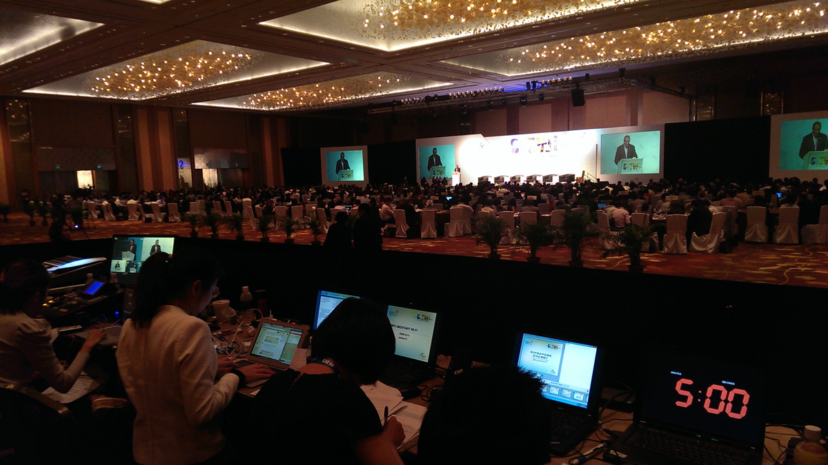 An operating position with equipment racks and laptops at the back of a banquet room.